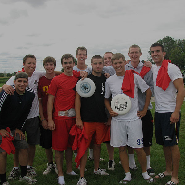 A frisbee team posing for a photo after practice.