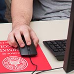 Male hand using a computer mouse.