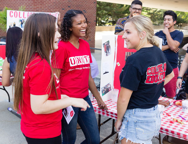 COE students mingle at a pizza party event.