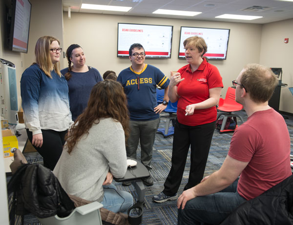 An instructor teaches her class of future Special Education teachers.