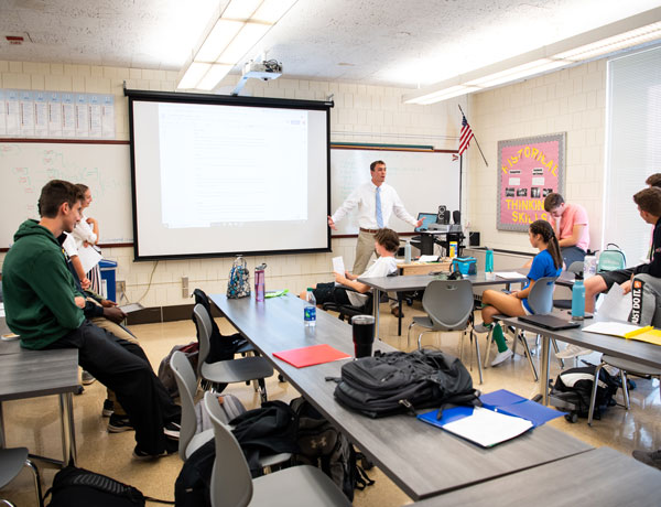 A student history teacher instructs at the University High School.