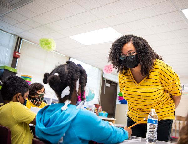 A student teacher listens to her student's question.