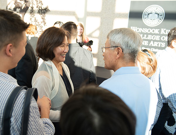 Namesake of the college, Wonsook Kim chats with the crowd after the naming ceremony.