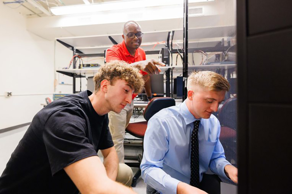 Undergraduate students Ryan Bredesen (left) and Alex Clark (right) researched cybersecurity in summer 2024 with faculty mentor Dr. Stephen Mujeye Sr. through the Office of Student Research's FIREbird program.