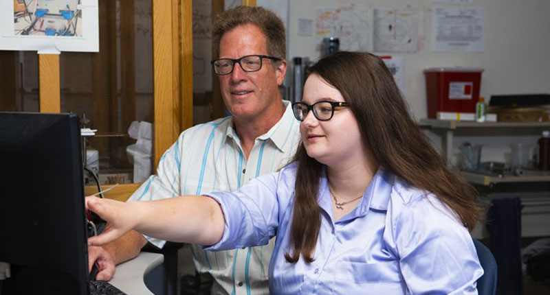 Distinguished Professor of Neurobiology Dr. Paul Garris, left, and graduate assistant Rebecca Chicosky analyze data collected in Garris' lab.